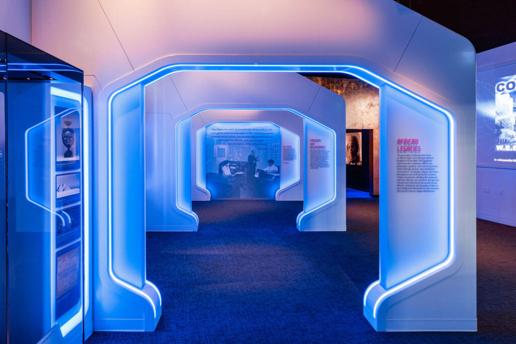 a series of glowing archways in an Afrofuturism exhibit