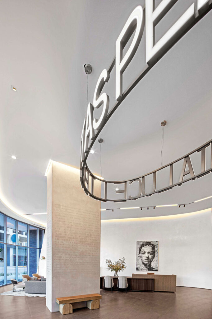 sleek high tech lobby space with white pillars and sign