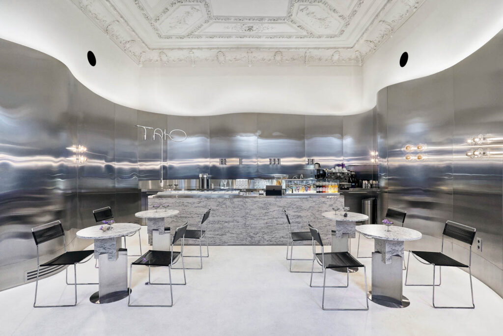 a gray interior with black stools inside Tanu Gelaterie in Ukraine