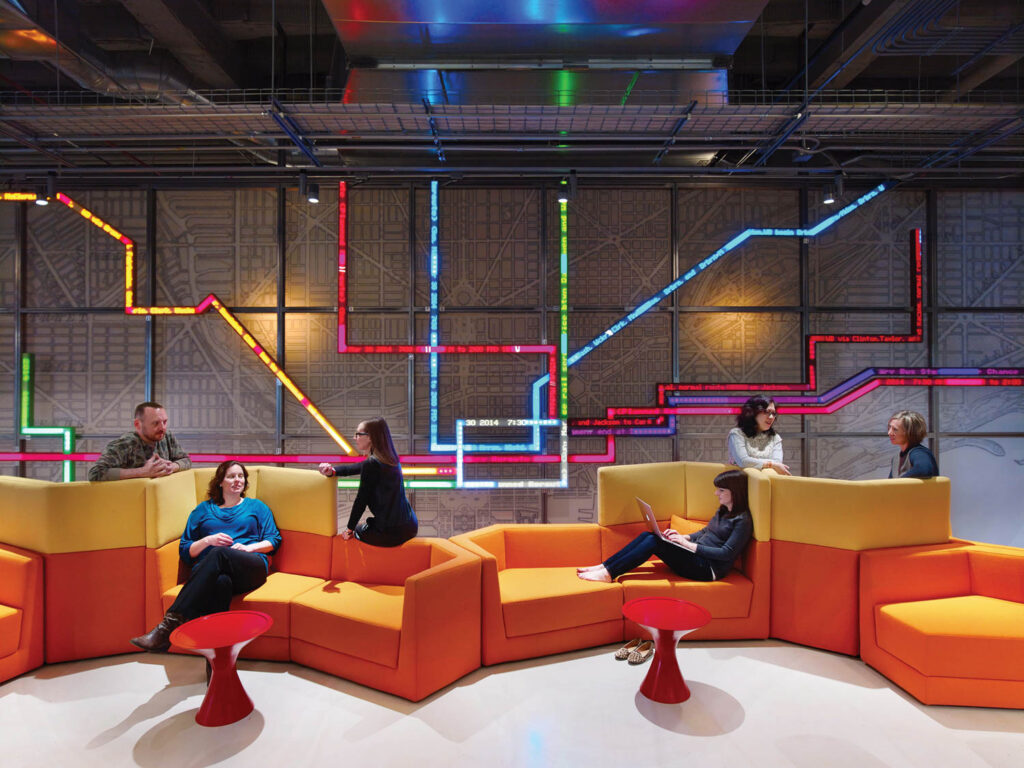 employees working on a geometric orange bench