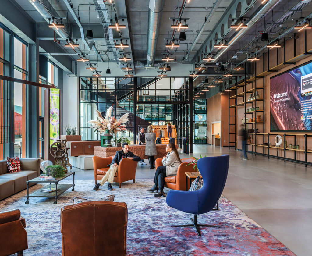 people sitting in blue and brown armchairs in a lounge area