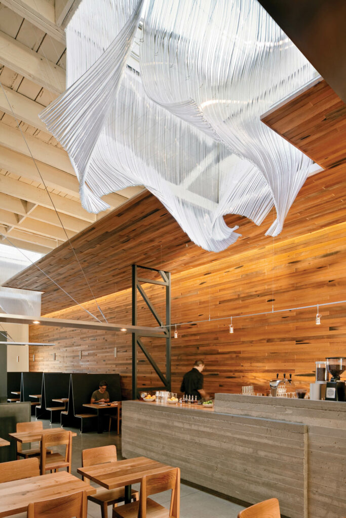 a wood paneled room with a hanging sculpture