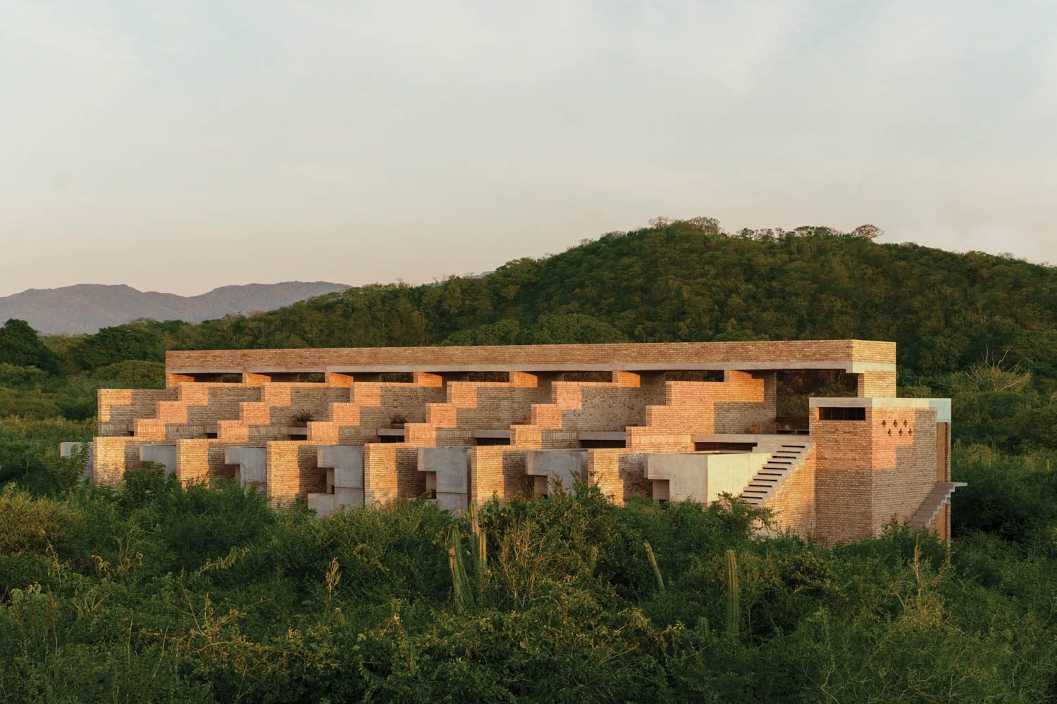 Sun-bleached artisanal bricks, hand-cast in Puebla, compose exteriors.