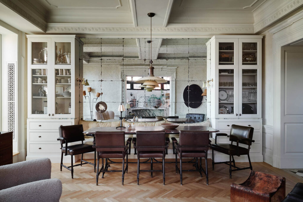 a dining area with white walls and cabinets