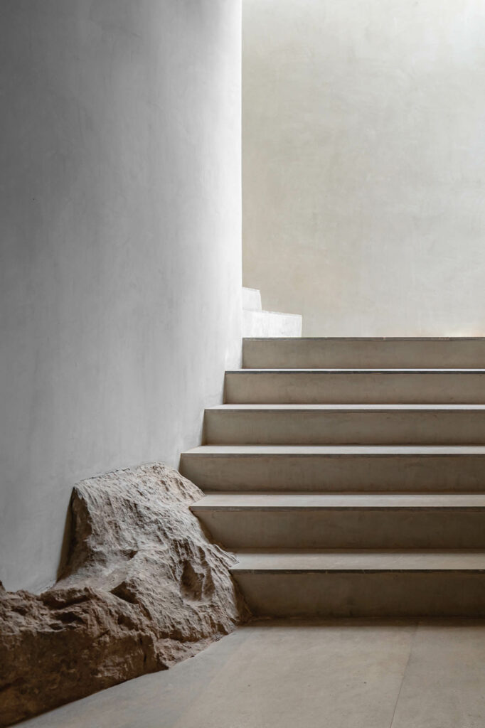 a staircase with rock formations on one side