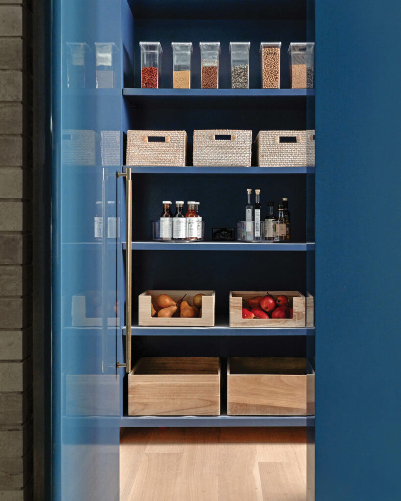 a blue pantry stocked with goods