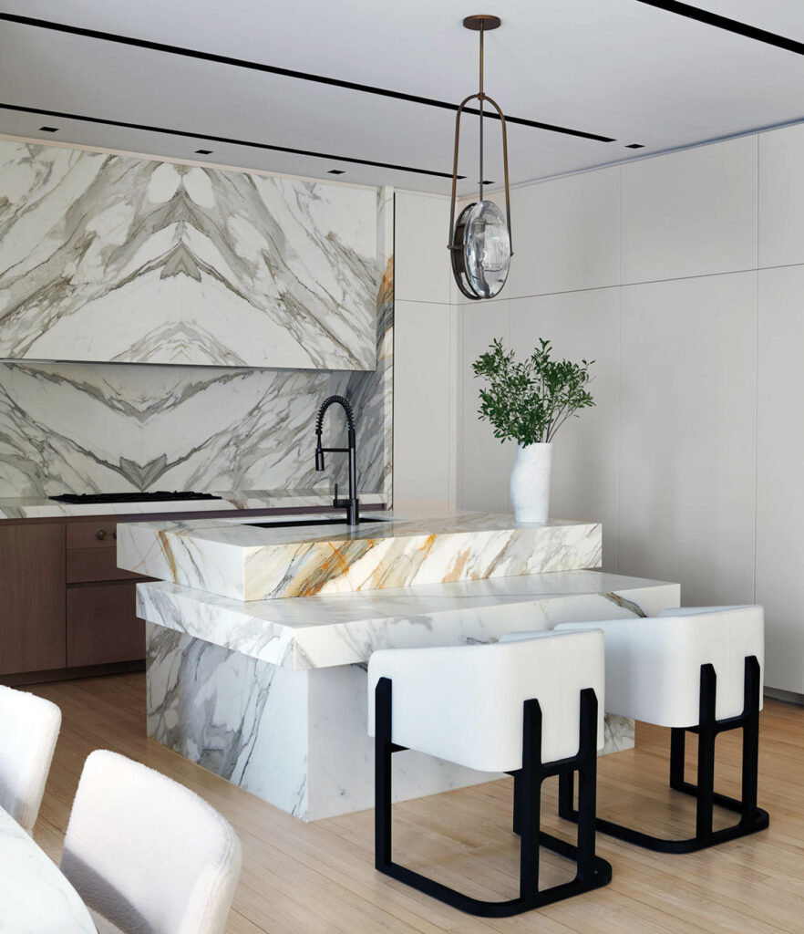 a white marble kitchen island with white stools