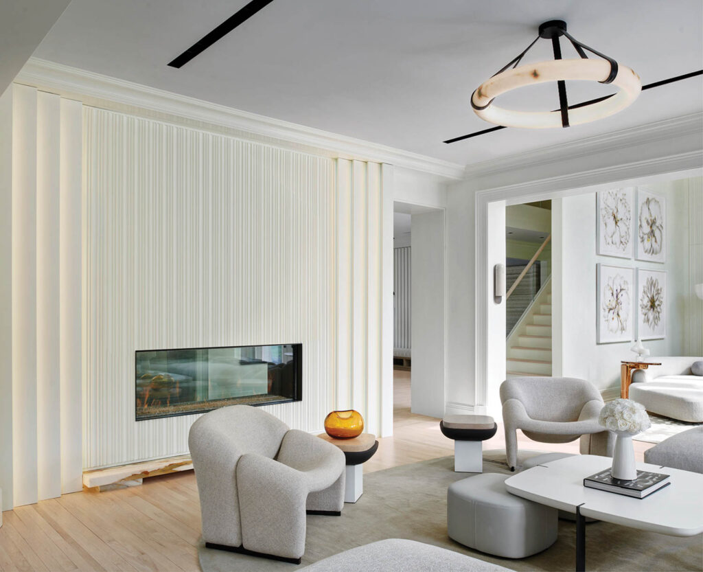 a living area with gray armchairs