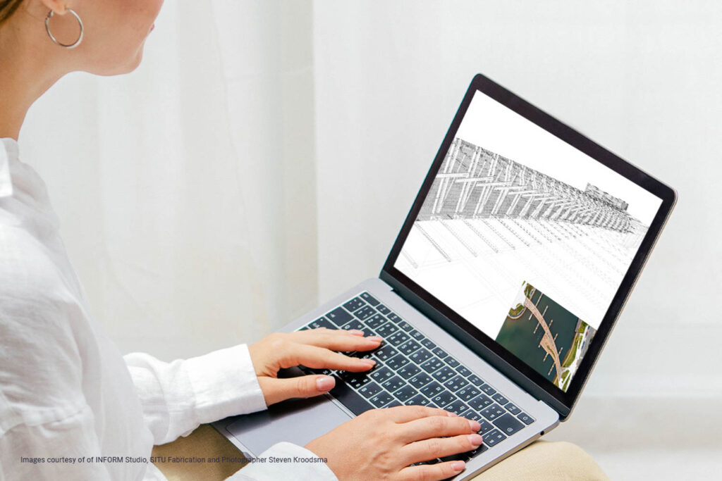 a woman works on a laptop