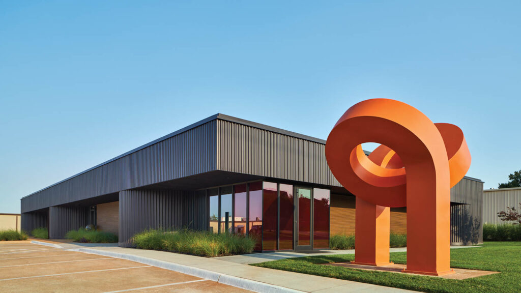 exterior facade of building with orange sculpture