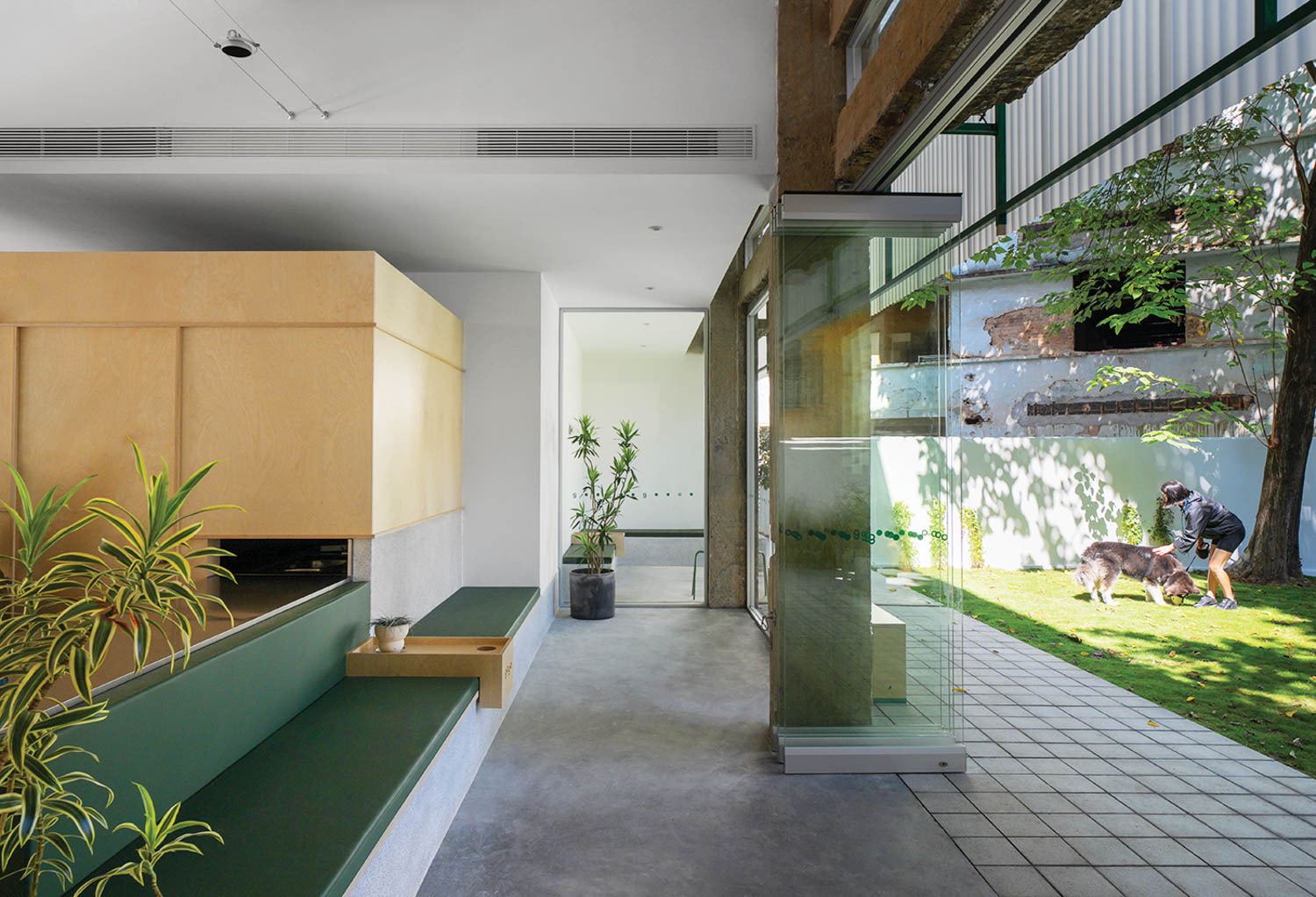 room with wooden cabinets, couches and view of the outdoors