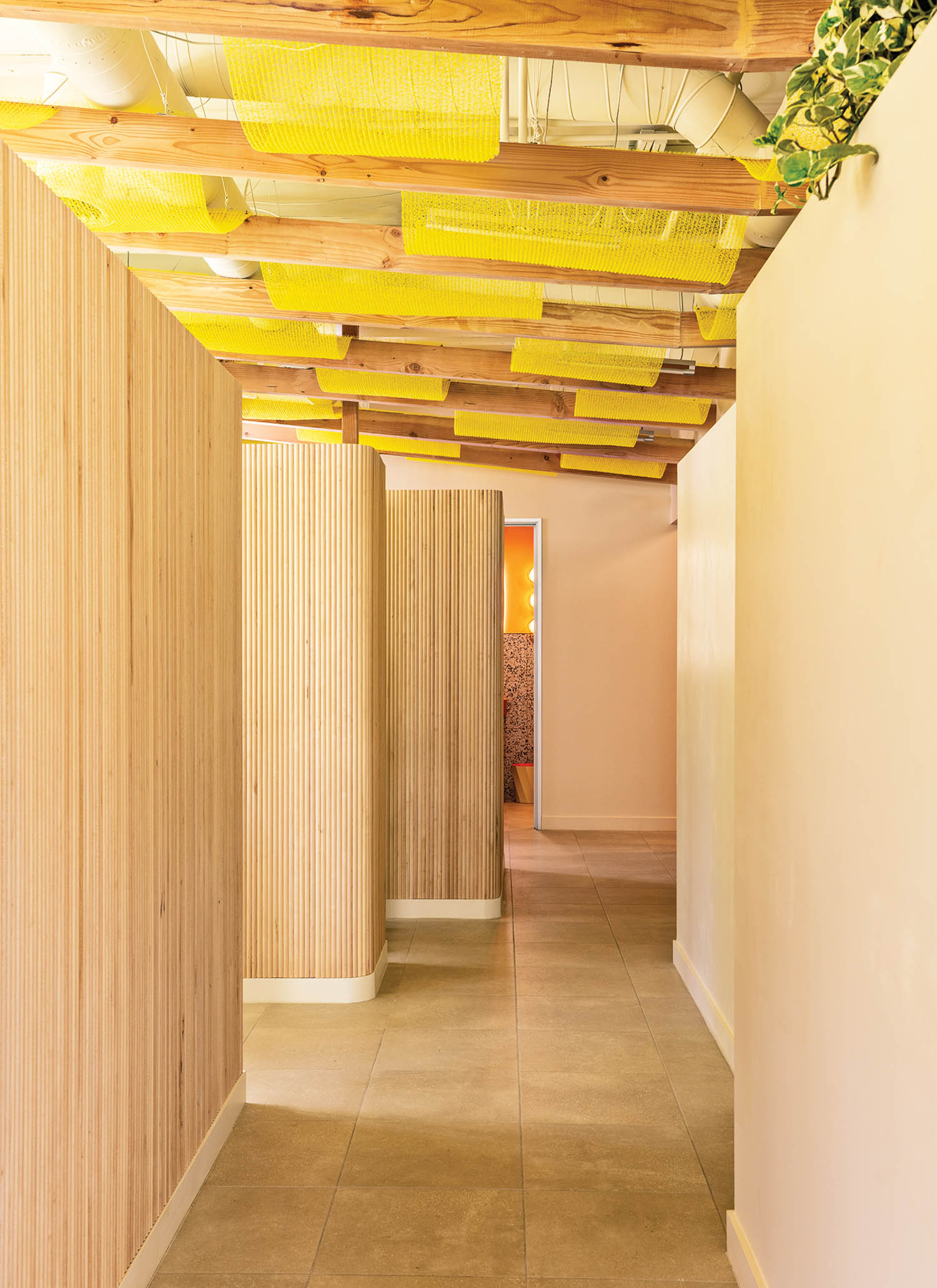 hallway with yellow ceiling and wooden paneled walls