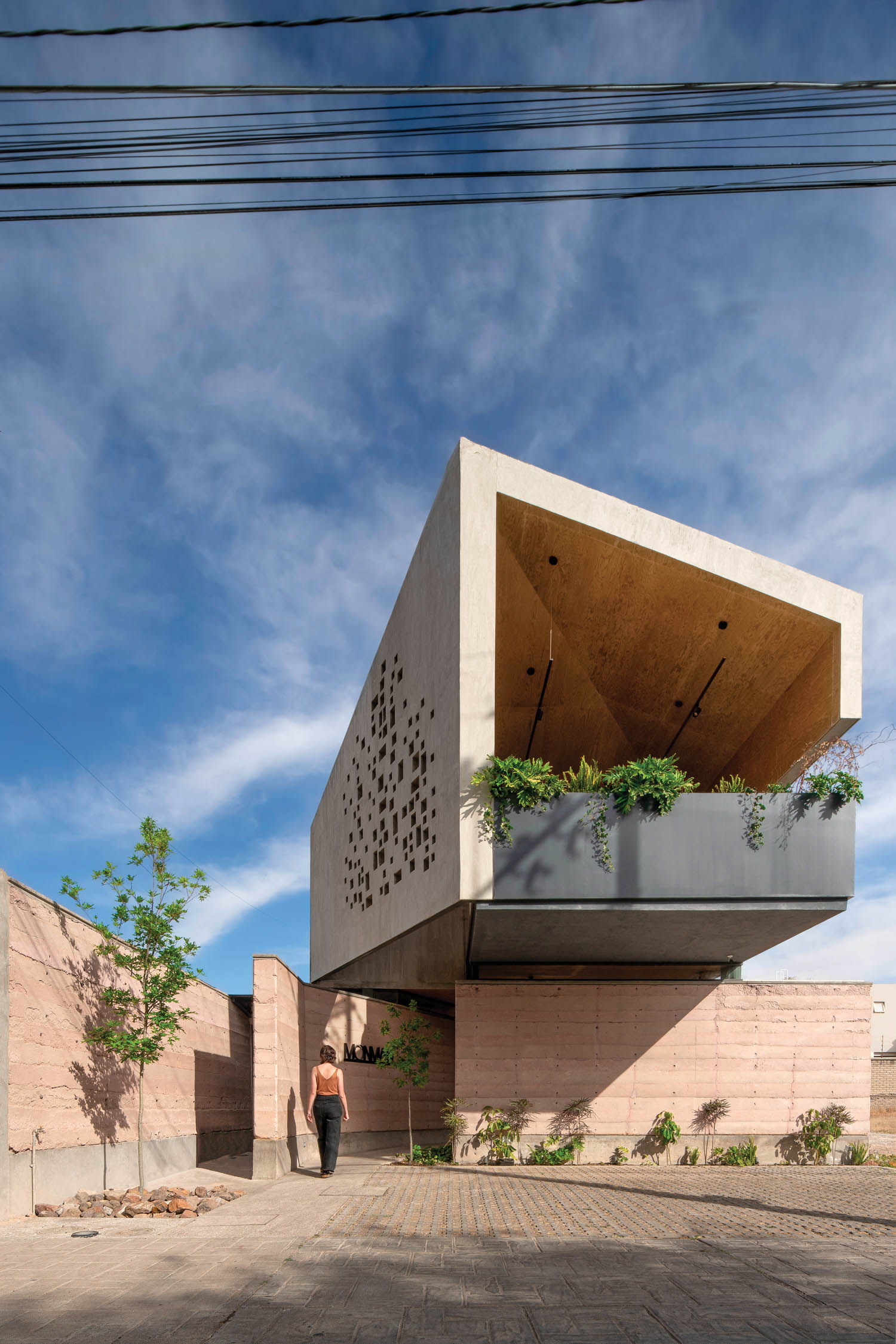 outdoor view of the restaurant with a square roof and tan walls