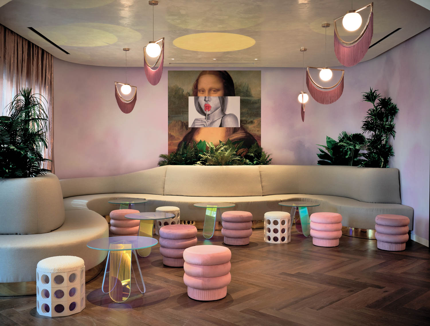 sitting area with long curvy sofa and Mona lisa portrait with mouth replaced with a lollipop