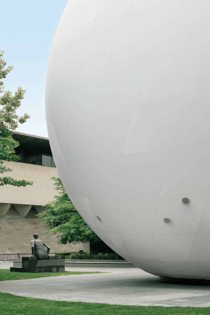 view of the white orb near a building for scale