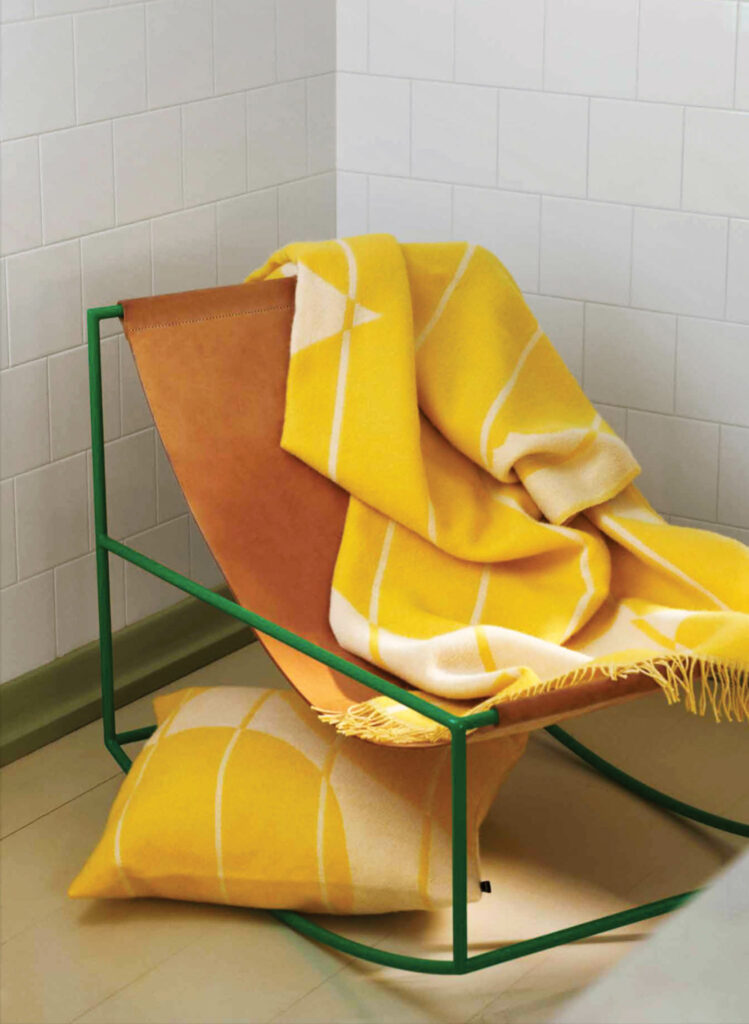 yellow blanket and pillow on a chair