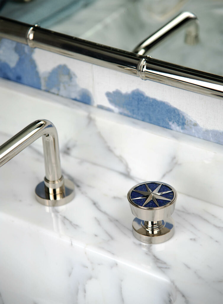 silver faucets on a marble sink