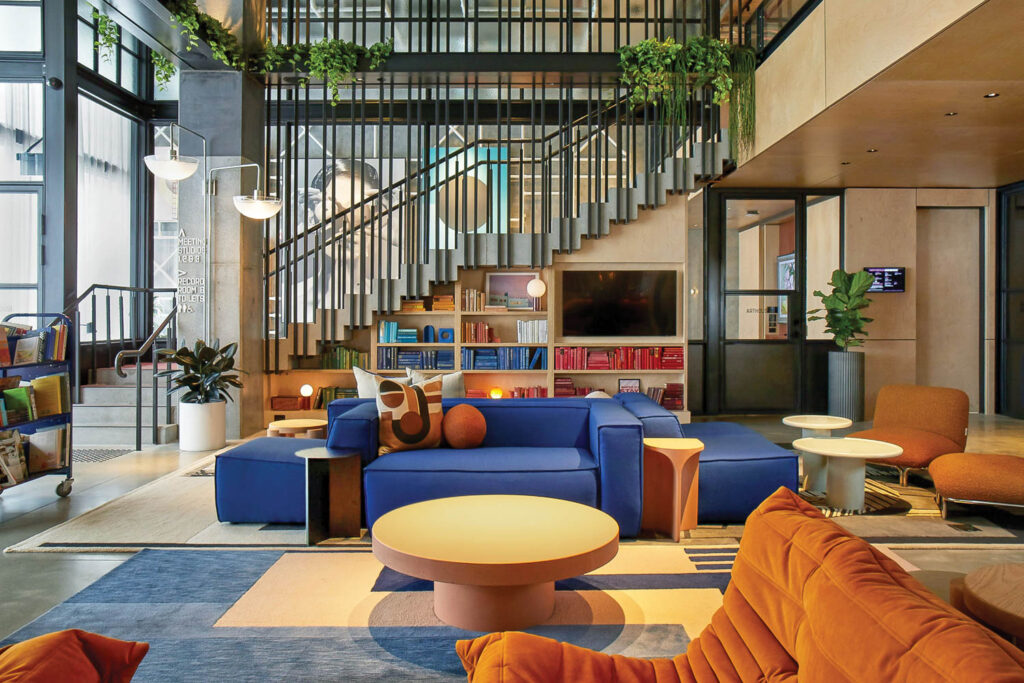 sitting room with bright blue seating area and orange gaming chairs