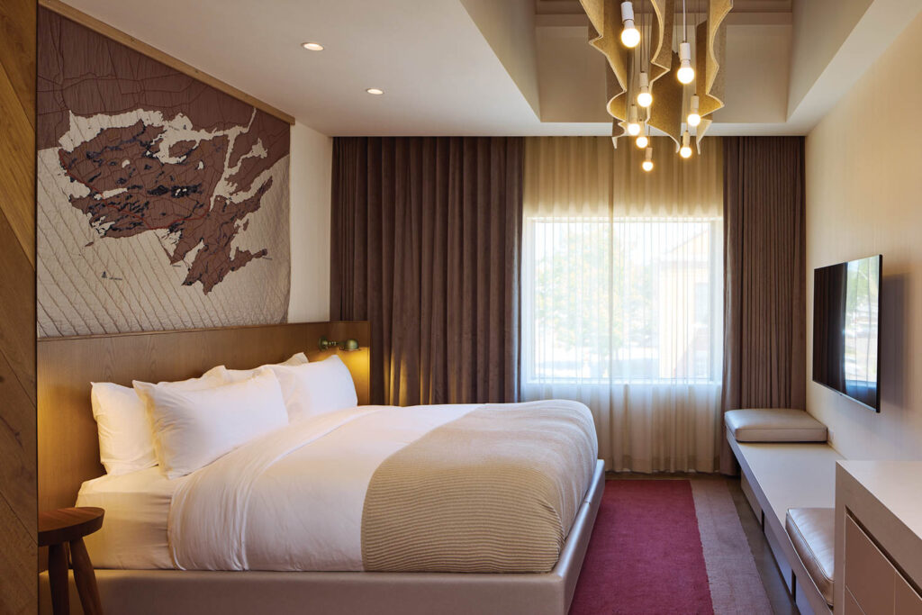 hotel bedroom with red carpet and brown drapes