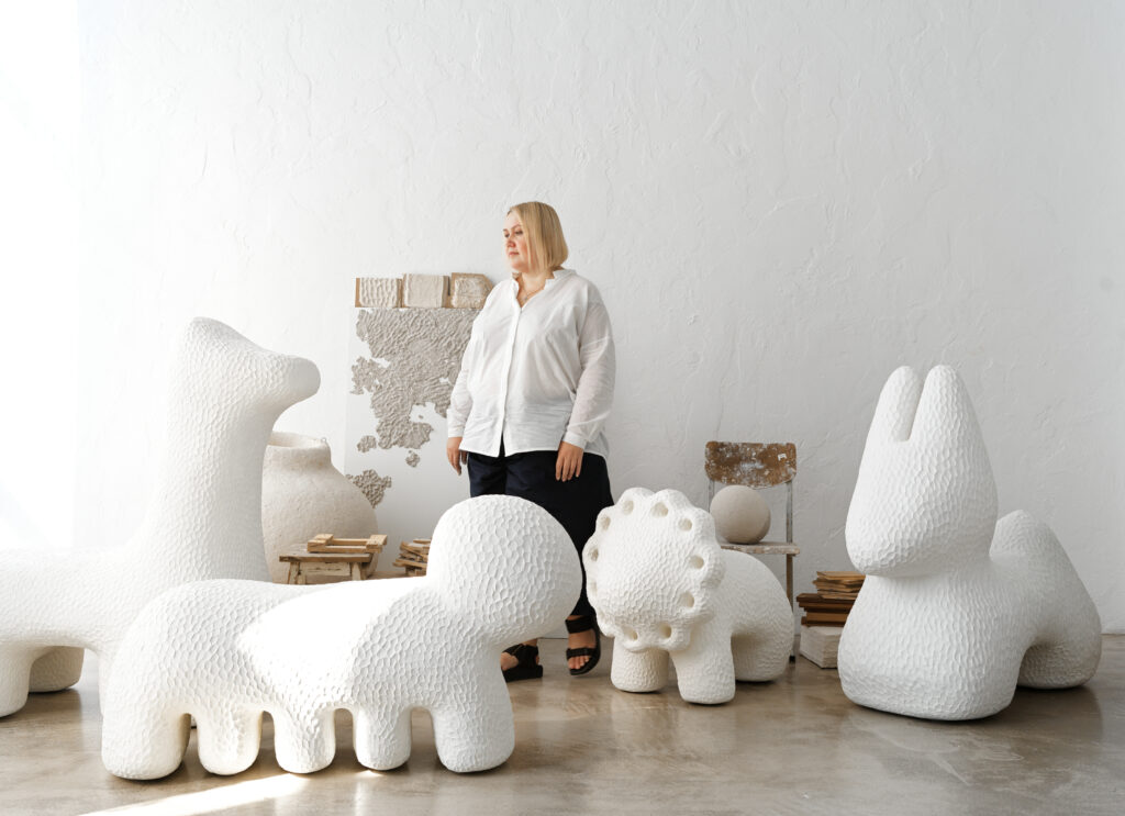 woman standing next to cloudlike animals